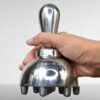 Hand holding an aluminum metal massage tool mushroom, ideal for cellulite treatment, body scraping, and Ice Body Sculpting.