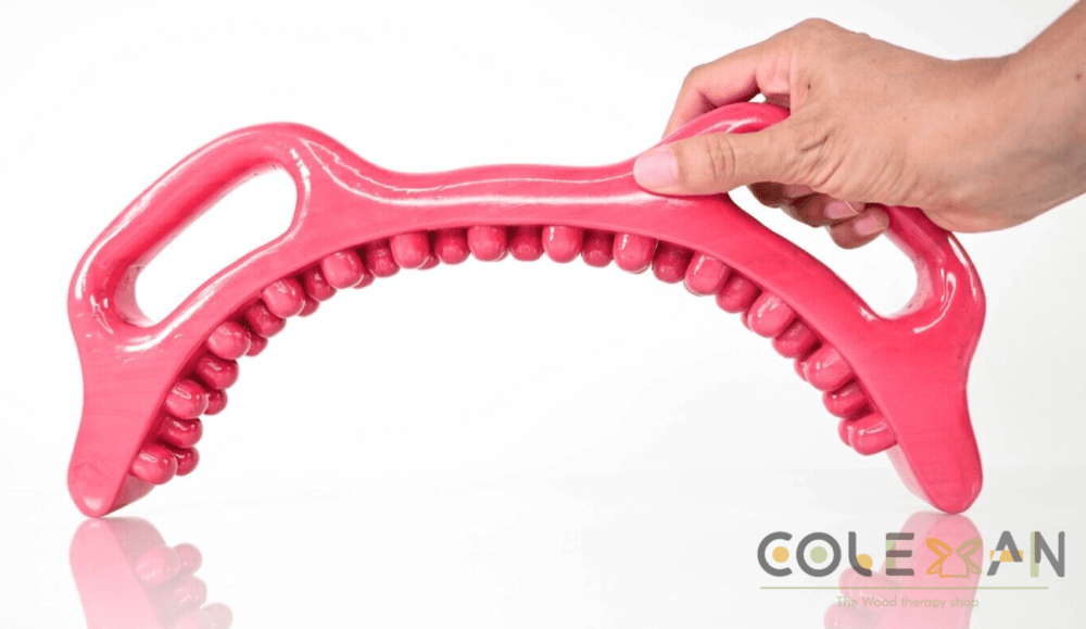 Hot pink half-moon shaped wooden waist massager with multiple fingers and two handles for easy gripping.
