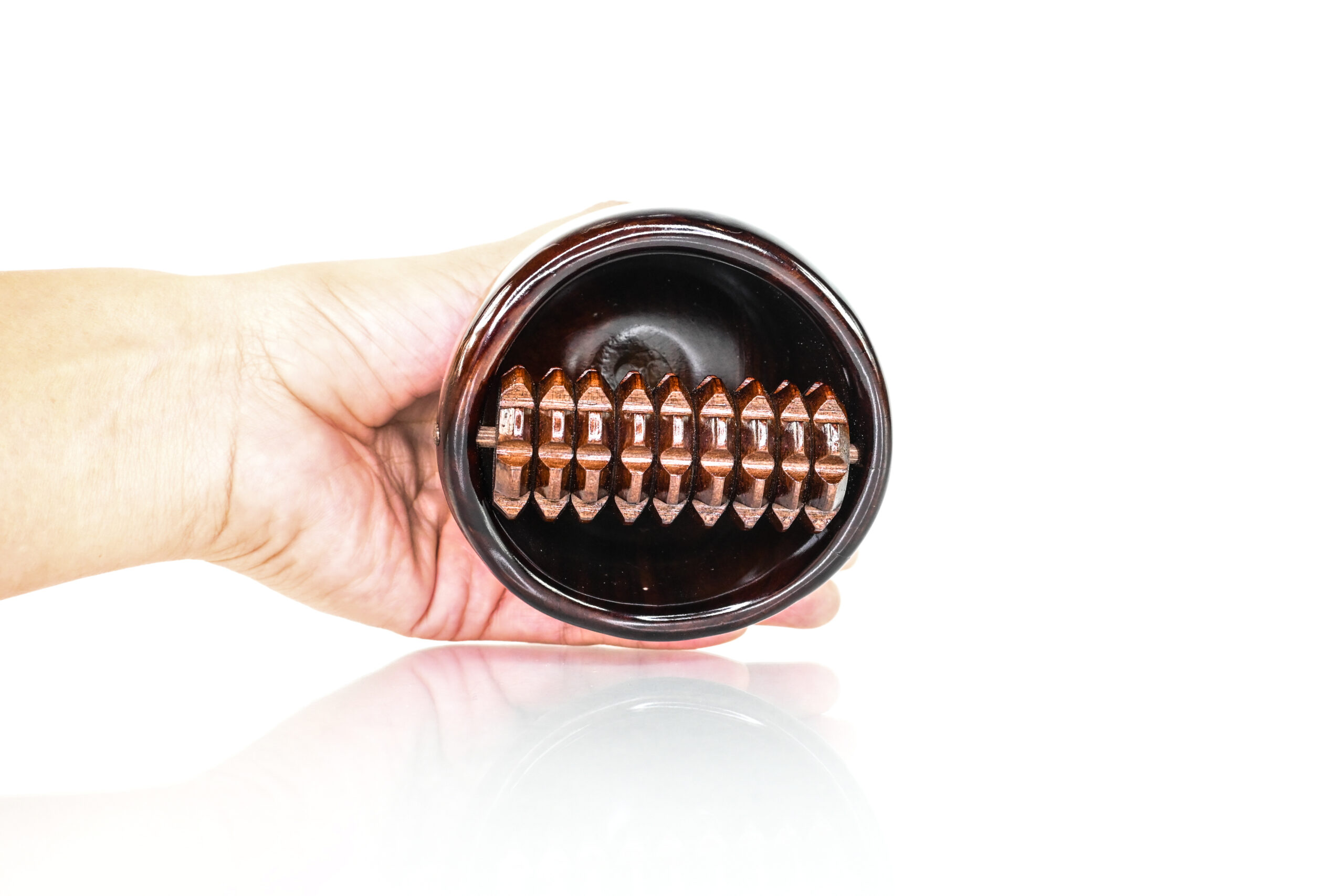 Textured cob roller inside wooden Swedish massage cup