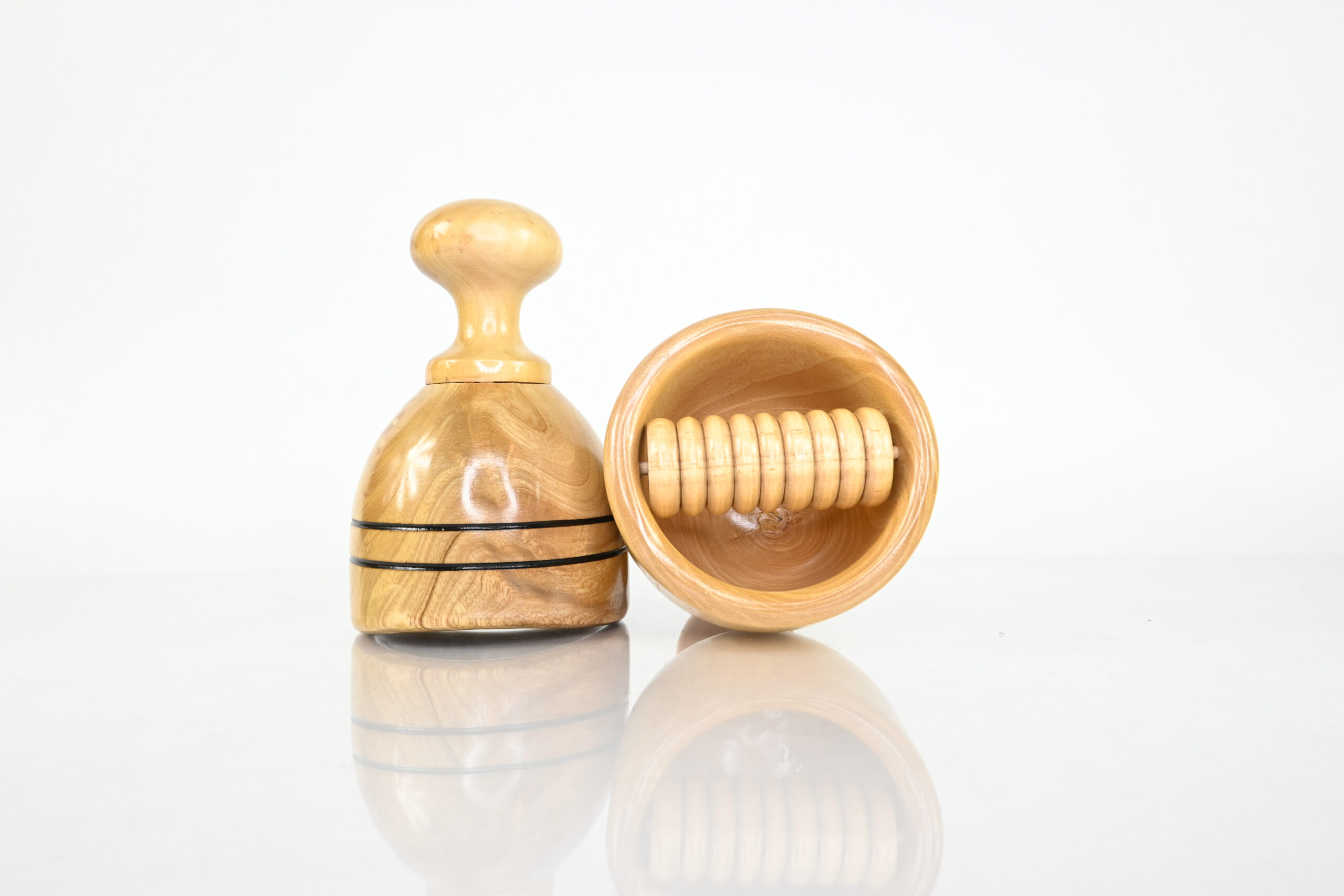 Swedish wood cup beside wood therapy cup with soft internal roller