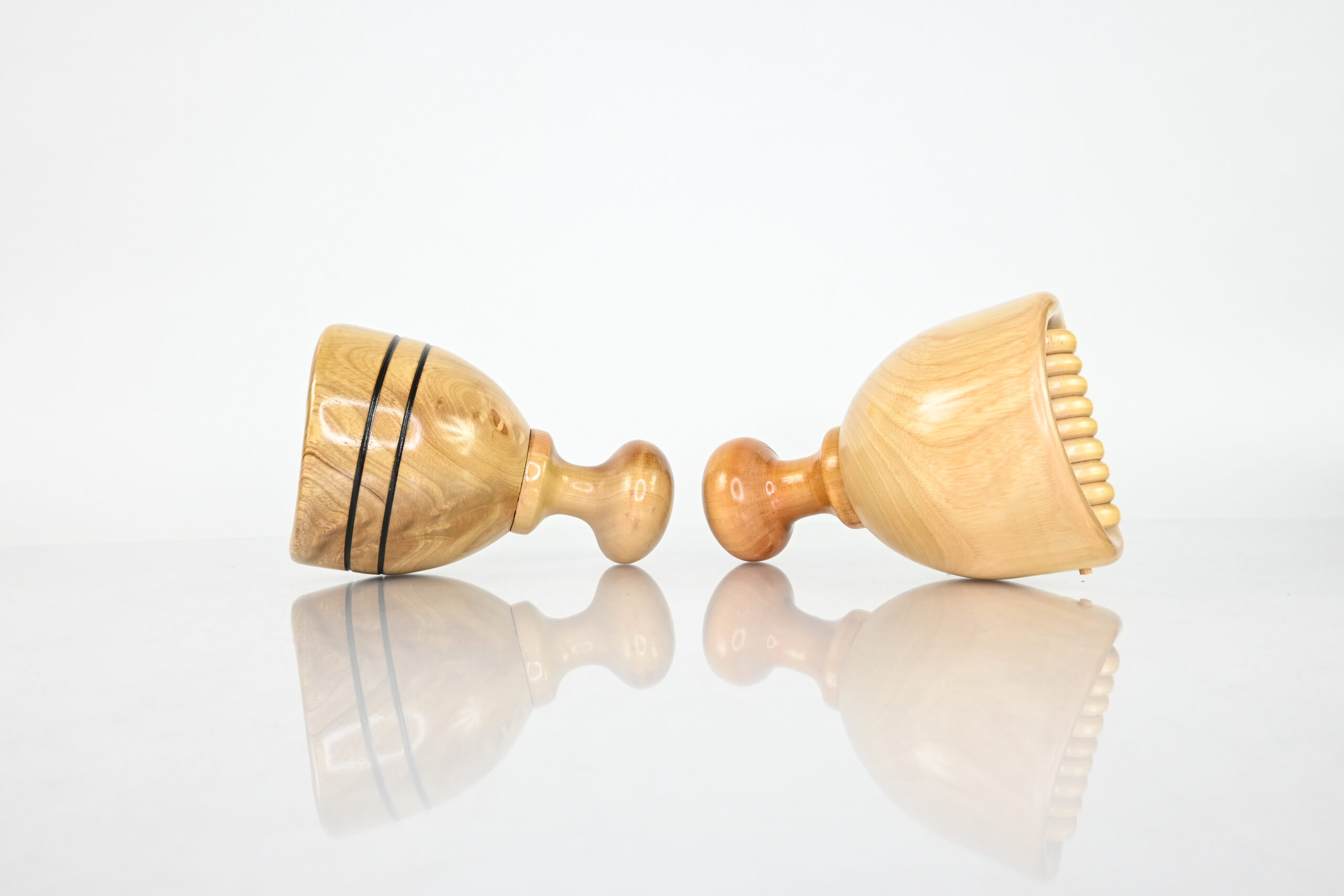 Side view of two short-handle Swedish wood therapy cups