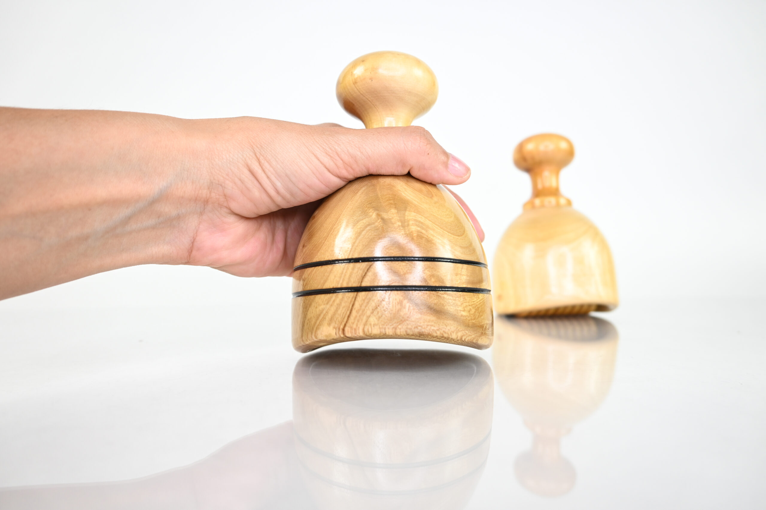 Soft roller wood therapy cup beside classic Swedish cup