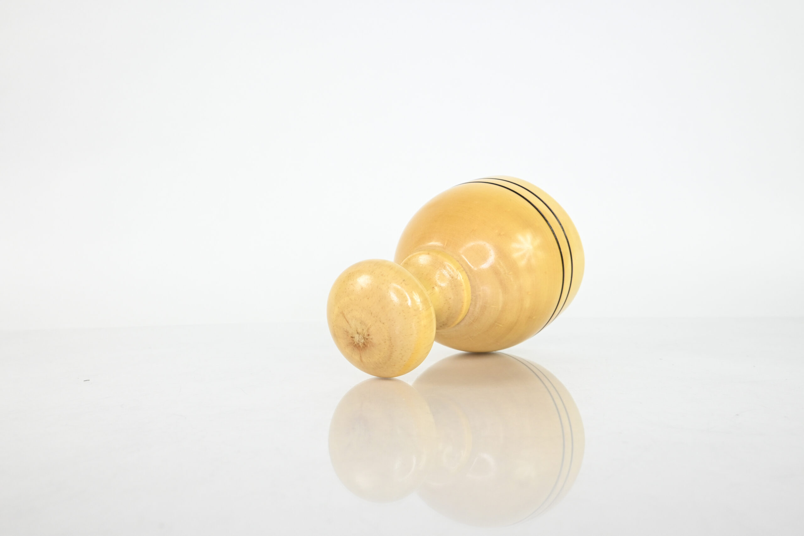 Hand holding the interior of a wooden Swedish massage cup